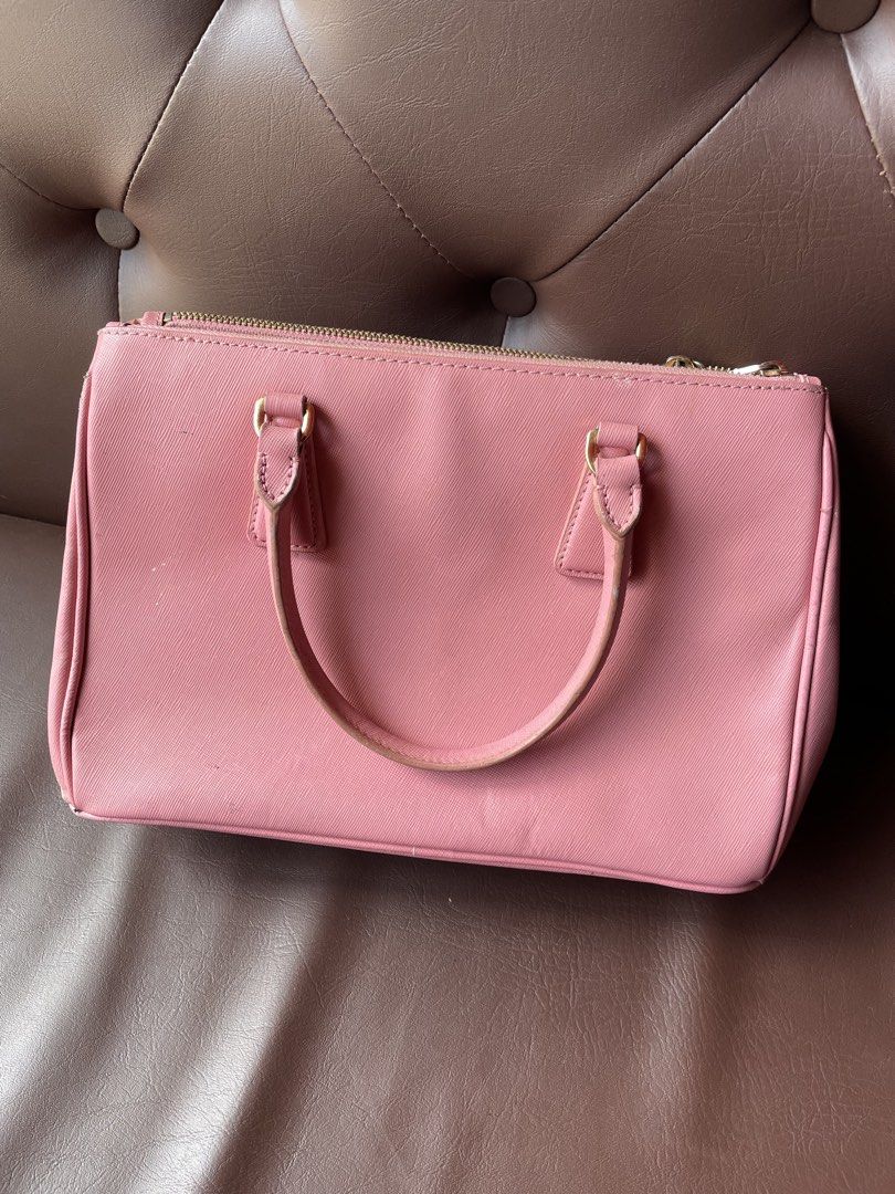 Prada Saffiano Leather Pink Top Handle Bag (Category: Luxury Bags & Wallets) located in Caloocan City. Submitted by trippsnthrifts (Listing ID 1459731810, Image 2). Description: - Authentic Prada bag in pink Saffiano leather - Made in Italy - Gold hardware details - Interior features Prada logo lining - Shows some signs of wear on handles and edges.