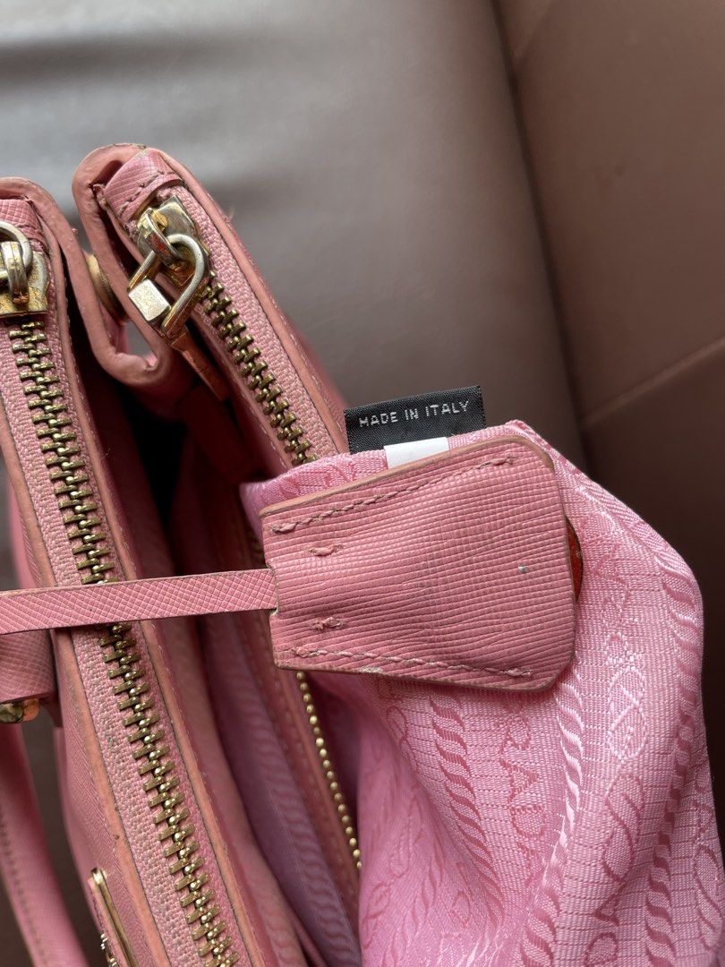 Prada Saffiano Leather Pink Top Handle Bag (Category: Luxury Bags & Wallets) located in Caloocan City. Submitted by trippsnthrifts (Listing ID 1459731810, Image 3). Description: - Authentic Prada bag in pink Saffiano leather - Made in Italy - Gold hardware details - Interior features Prada logo lining - Shows some signs of wear on handles and edges.