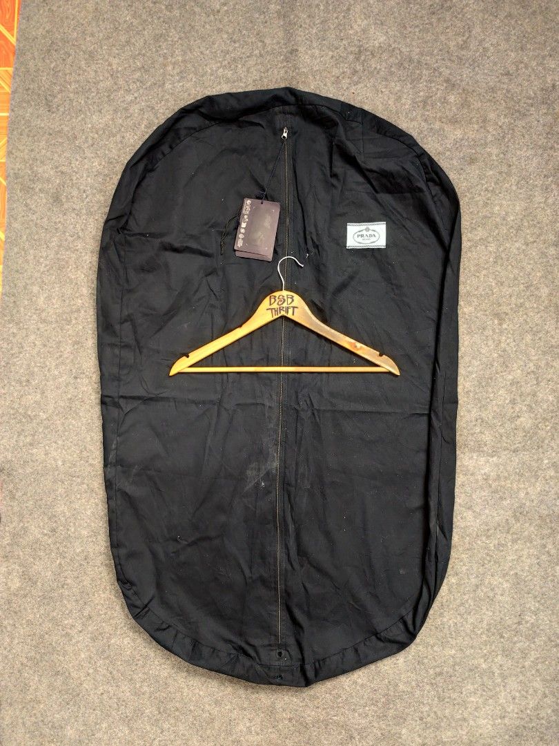 Prada Suit Cover Bag (Category: Luxury Bags & Wallets) located in Cordova. Submitted by bsb.streetluxvintage.clothing (Listing ID 1459784194, Image 2). Description: - Black Prada garment bag - Includes original tag and dust bag - Zipper closure - Ideal for storing or transporting suits and dresses - Keeps clothes protected and wrinkle-free.