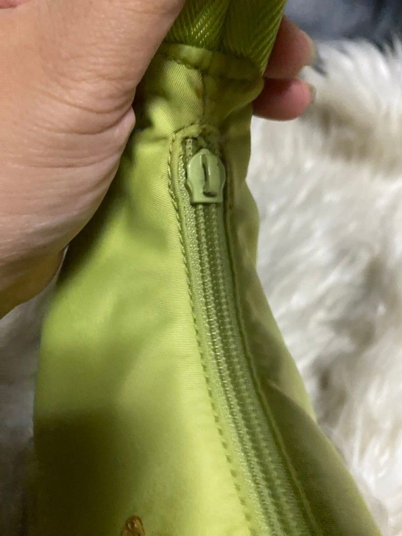 Preloved PRADA kili kili bag (Category: Luxury Bags & Wallets) located in Subic. Submitted by melyn.duhxx (Listing ID 1459698615, Image 3). Description: ISSUE: Zipper puller missing. Nilagyan ko nalang ng doll chain para alternative zipper nya. Small stain, not very visible when using kayo nalang mag pa clean. Other than that all goods na. From Japan box. Amoy package pa..