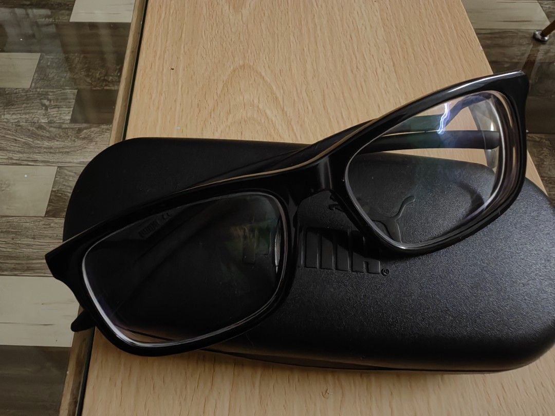 Puma Black Eyeglasses with Case (Category: Sunglasses & Eyewear) located in Cavite. Submitted by klosetnijuan (Listing ID 1459796468, Image 1). Description: Black Puma eyeglasses. Comes with a black Puma hard case. The frames are black with the Puma logo on the side. Good for everyday wear. Lenses are clear. Original price was 6k b.