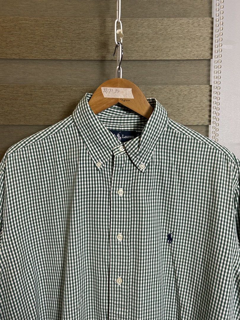 Ralph Lauren Gingham Button Down Shirt (Category: Tshirts & Polo Shirts ) located in Santa Ana. Submitted by thrift.sanctuary (Listing ID 1459734521, Image 2). Description: 32,26-27 Classic green and white gingham shirt from Ralph Lauren. 100% cotton, made in Vietnam. Features the iconic polo player logo embroidered on the chest. Button-down collar. Great for casual or smart-casual wear. Check the label for care instructions..