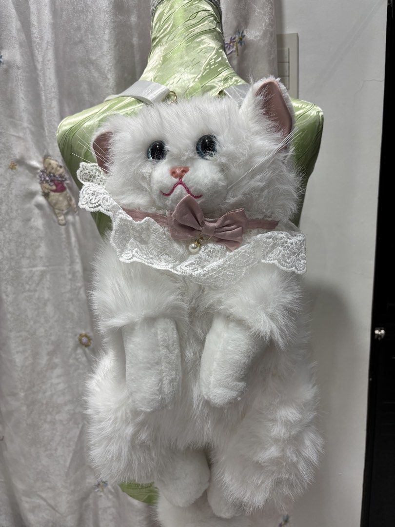 Realistic Cat Plush with Lace Collar Backpack (Category: Plushies & Soft Toys) located in Mexico. Submitted by 3everything (Listing ID 1459744502, Image 1). Description: - Adorable white fluffy cat plush backpak - Big, captivating blue eyes and a cute pink nose - Dressed in a delicate white lace collar with a pink bow and pearl accent - Exceptionally soft and fluffy fur, irresistible to touch .