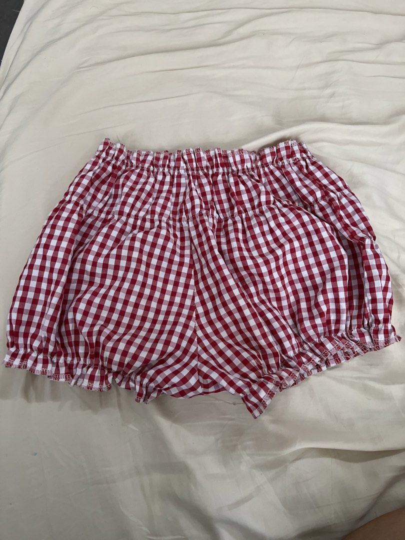 Red and White Gingham Ruffle Shorts (Category: Shorts) located in Pasig City. Submitted by crybaby666 (Listing ID 1459756140, Image 1). Description: - Adorable red and white gingham pattern - Comfortable elastic waistband - Sweet ruffle trim at the hem - Ideal for casual outings or lounging - Versatile and easy to style with any top.