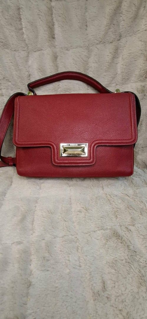 Red Leather Handbag/slingbag with Gold Clasp (Category: Luxury Bags & Wallets) located in Manila. Submitted by mysticfox.9b1678 (Listing ID 1459736065, Image 1). Description: - Classic red leather handbag - Gold-tone rectangular clasp closure - Top handle and detachable shoulder strap - Textured leather finish - Spacious interior for essentials - Versatile for everyday or special occasions.