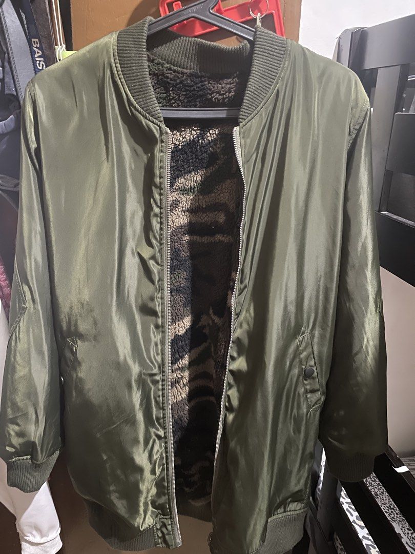 Reversible Camo Fleece Bomber Jacket (Category: Coats, Jackets and Outerwear) located in Muntinlupa City. Submitted by dormammu83 (Listing ID 1459867567, Image 2). Description: - Reversible olive green bomber jacket - One side: Shiny satin material - Other side: Fuzzy camouflage print - Ribbed collar, cuffs, and hem - Zipper closure - Two side pockets (on camo side) - Ideal for layering.