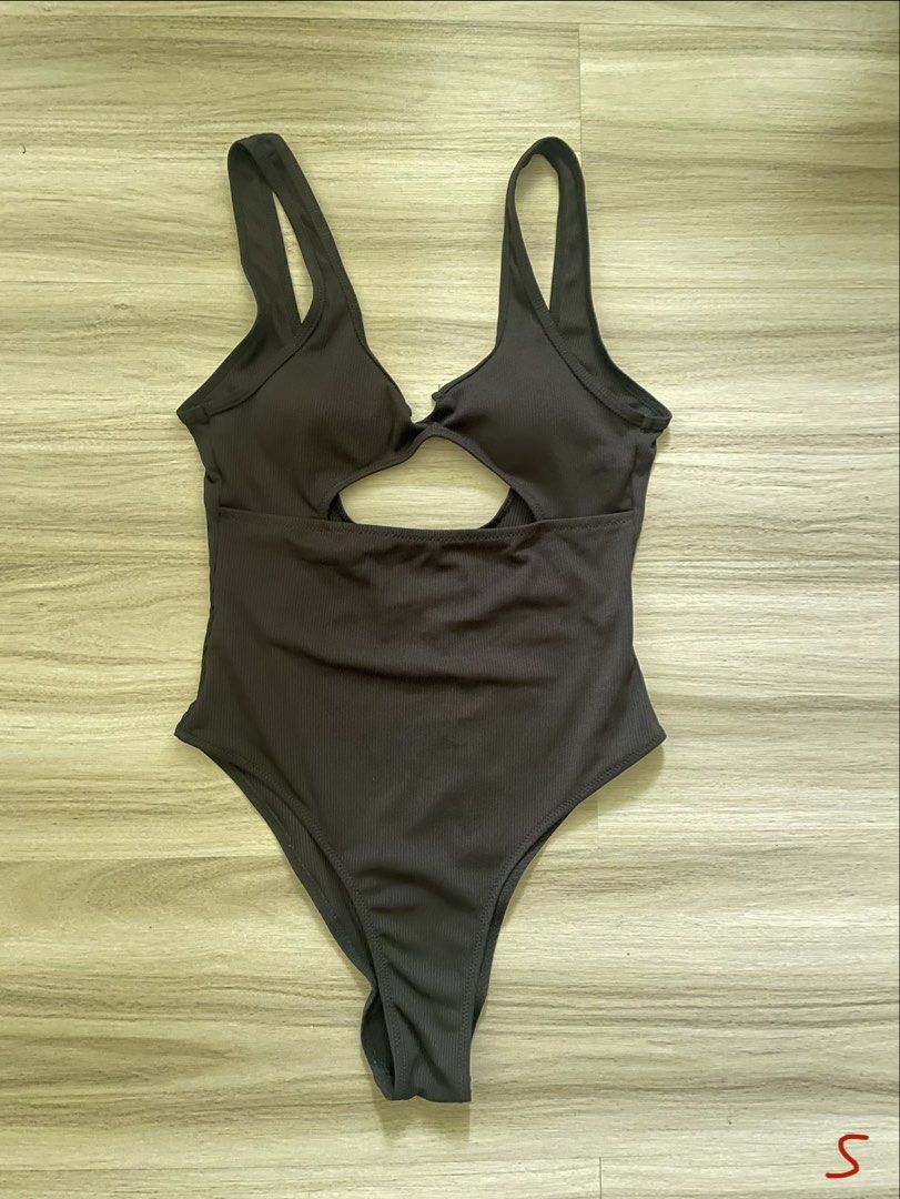 Ribbed Cut-out One-Piece Swimsuit (Category: Bikinis & Swimsuits) located in Manila. Submitted by possiblymaybe.717 (Listing ID 1459783211, Image 1). Description: - Dark grey ribbed one-piece swimsuit - Features a front cut-out detail - Flattering high-leg cut - Strappy design - Perfect for beach or pool days.