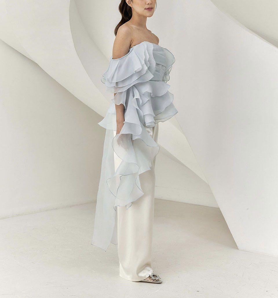 Ruffled Organza Top (Detachable off-shoulder (Category: Blouses) located in Quezon City. Submitted by lalaspirit (Listing ID 1459764965, Image 2). Description: Giea Ceylia Top (Indonesian Brand) Never Worn Color: Pastel Blue / Muted Blue M | Bust 78-88 Waist 74 Hip 104 Length 62 - Satin lining and fully overlaid with sheer organza - Features a fitted, boned bodice with a flattering drape overlay for added structure and support - Detachable frille