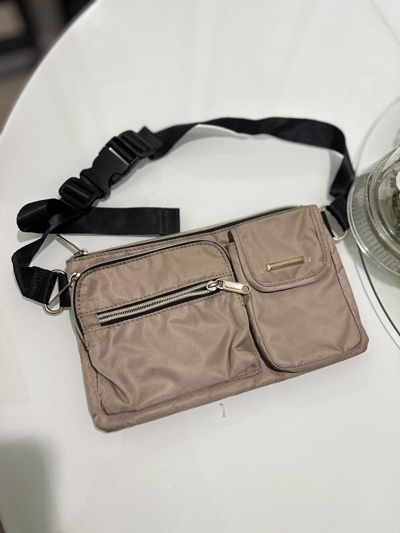 Rurubu Waist Pouch Bag (Category: Purses & Pouches) located in Mandaluyong City. Submitted by TheWeekendProject (Listing ID 1459762073, Image 1). Description: - Stylish tan/beige waist pouch - Multiple pockets and zippers for organization - Adjustable strap for versatile wear (waist or crossbody) - Ideal for travel and everyday use - Clean interior and exterior - Ready for its next adventure!.