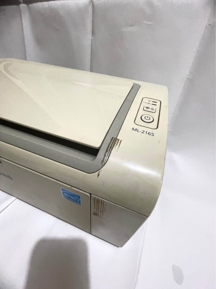 Samsung ML-2165 Monochrome Laser Printer (Category: Printers, Scanners & Copiers) located in Valenzuela. Submitted by newhorse.27726b (Listing ID 1459847659, Image 2). Description: - Samsung ML-2165 monochrome laser printer - Compact size, ideal for home or small office - Reliable for everyday printing needs - Tested and confirmed working - Minor exterior scuffs and signs of use (expected for pre-owned) - Issue: No Ink.