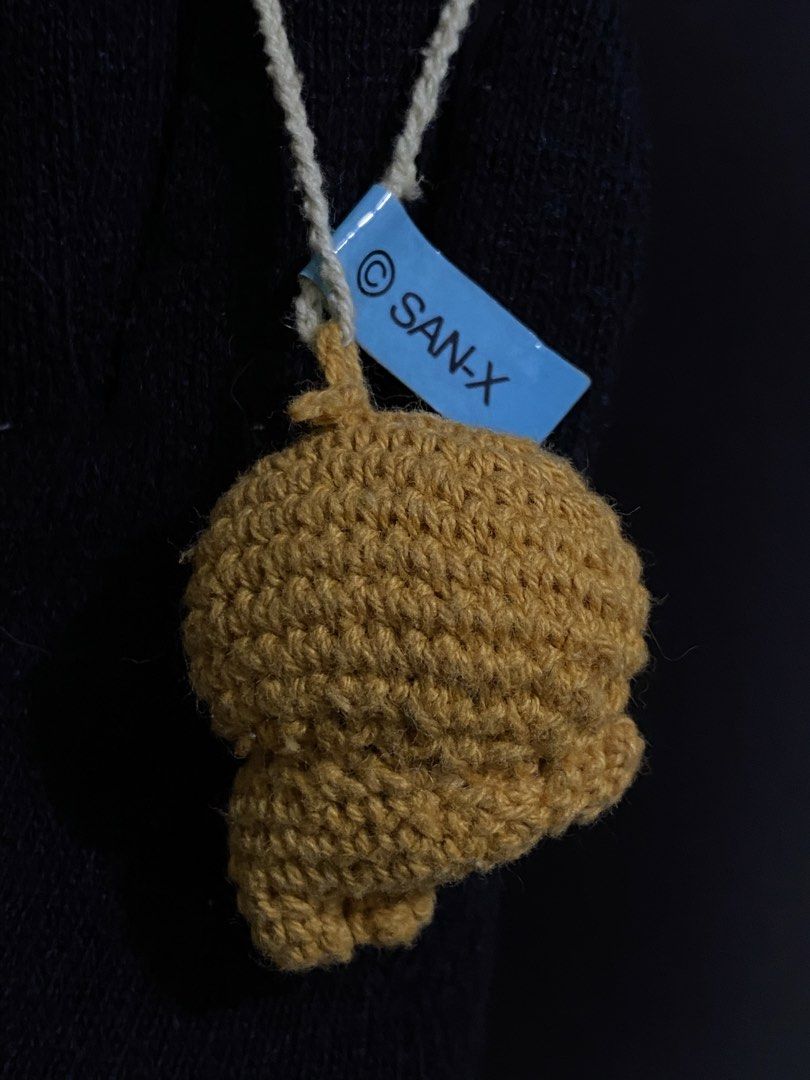 San-X Crochet Plush Charm with Tag (Category: Handmade Craft) located in Davao. Submitted by hoowans_surplus (Listing ID 1459886901, Image 2). Description: - Adorable crochet plush charm - Yellowish-brown color - Features a convenient hanging string - Includes original San-X tag - Ideal for decorating bags or keys - Small and portable design.