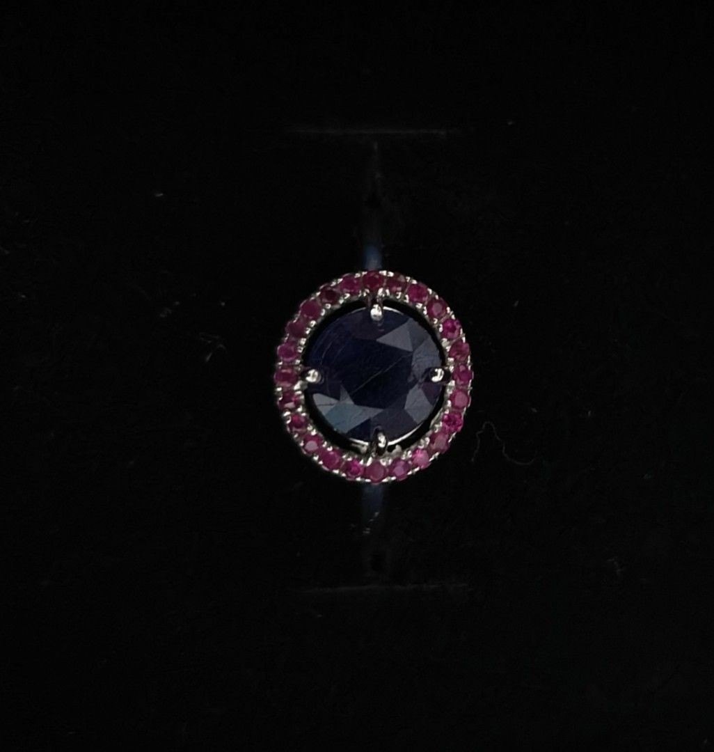 Sapphire and Ruby Ring (Category: Rings) located in Batangas. Submitted by decluttering_bliss (Listing ID 1459801688, Image 1). Description: - Elegant silver ring - Features a striking blue sapphire gemstone - Surrounded by sparkling ruby gemstones - Classic and timeless design - Versatile for everyday wear or special events - Includes a beautiful blue ring box.