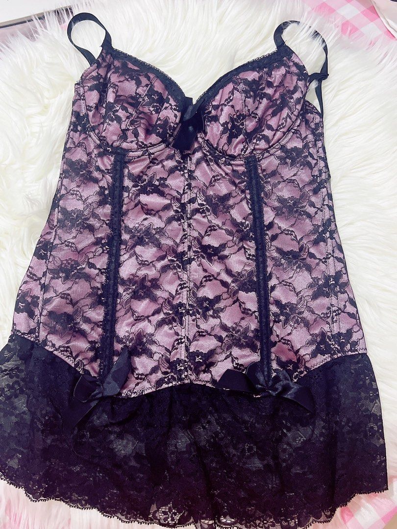 Satin Pink Lacey Corset (Category: Others Tops) located in Cavite. Submitted by wishie_collects (Listing ID 1459898812, Image 2). Description: Style: A pink satin-base corset top featuring a black floral lace overlay. Details: Accented with adjustable spaghetti straps, a central black bow at the bust, vertical boning channels, and dual small side bows near the scalloped black lace ruffle hem. Size Small.