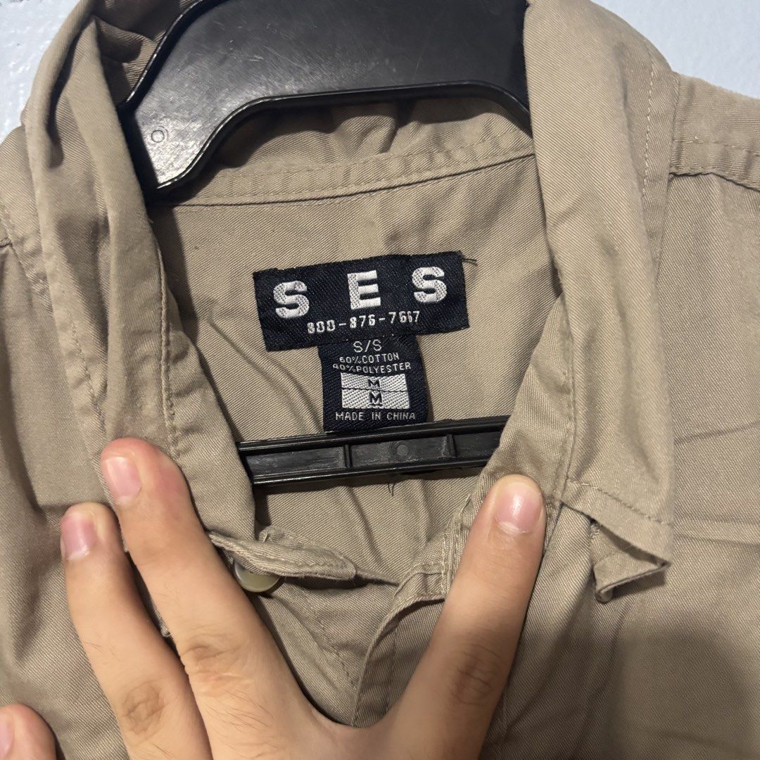 SES Short Sleeve Button Up Shirt Khaki Size M (Category: Shirts) located in Manila. Submitted by shosellthrift (Listing ID 1459762162, Image 2). Description: - SES Khaki Short Sleeve Button Up Shirt - Size: Medium (M) - Material: 60% Cotton, 40% Polyester - Features: Button closure, chest pocket - Style: Classic, simple, suitable for casual or work wear.
