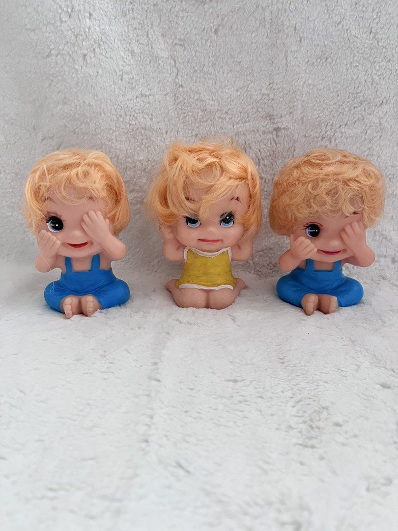 Kewpie or Moody dolls (Category: Kids Toys) located in Zamboanga. Submitted by wilthearey91043 (Listing ID 1459719568, Image 1). Description: - Set of 3 adorable baby dolls - Features blonde hair and blue overalls - One doll includes a yellow top - Hollow bottoms for a unique touch - Ideal for doll collectors or as a fun decor piece - Playful and charming appearance.