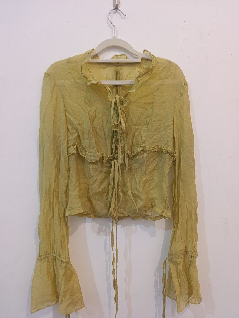 Sheer Tie-Front Ruffle Blouse with Bell Sleeves (Category: Blouses) located in Manila. Submitted by talline.122 (Listing ID 1459804000, Image 1). Description: Brand: N/A Color: Olive Style: Cropped Blouse with Bell-sleeves Price: 75 Size: Small to Medium Mode of Payments: ๑ Gcash (preferred!) ๑ Maya ๑ GoTyme For Meet Up: ๑ LRT 2 - Marikina Pasig Station, Katipunan Station ๑ UP Diliman Campus For Shipping: ๑ J&T Express ๑ Lalamove ๑ Grab No when w
