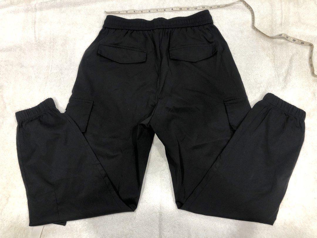 SHEIN Black Cargo Pants Size S (Category: Other Bottoms) located in Manila. Submitted by janmichael26601 (Listing ID 1459769009, Image 2). Description: - Black cargo jogger pants from SHEIN - Tagged size S - Elastic waistband with adjustable drawstring - Two side pockets and two back pockets - Jogger style with elastic cuffs - Ideal for everyday casual wear - Made in China.