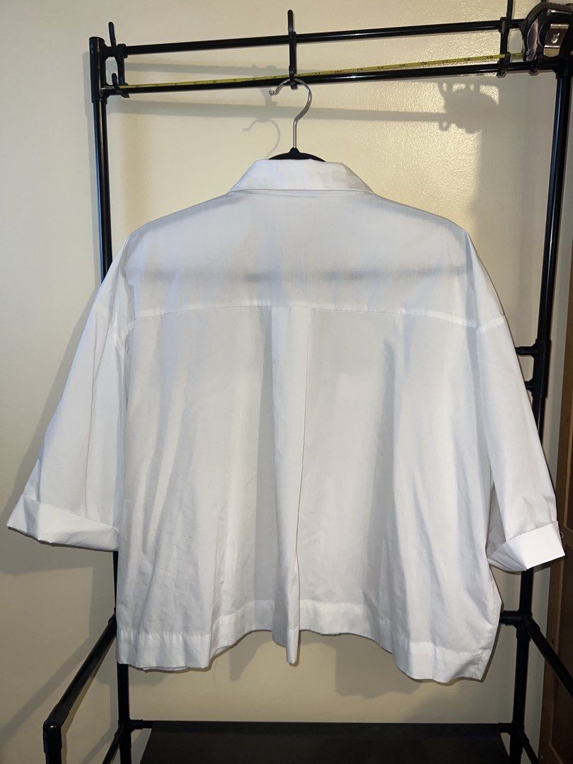 SHEIN White Cropped Oversized Button-Up Shirt (Category: Shirts) located in Mandaluyong City. Submitted by chelseayb47224 (Listing ID 1459815356, Image 2). Description: - SHEIN white button-up shirt - Cropped and oversized fit - Two chest pockets - Short sleeves with cuff - Easy to style for casual or dressy looks.