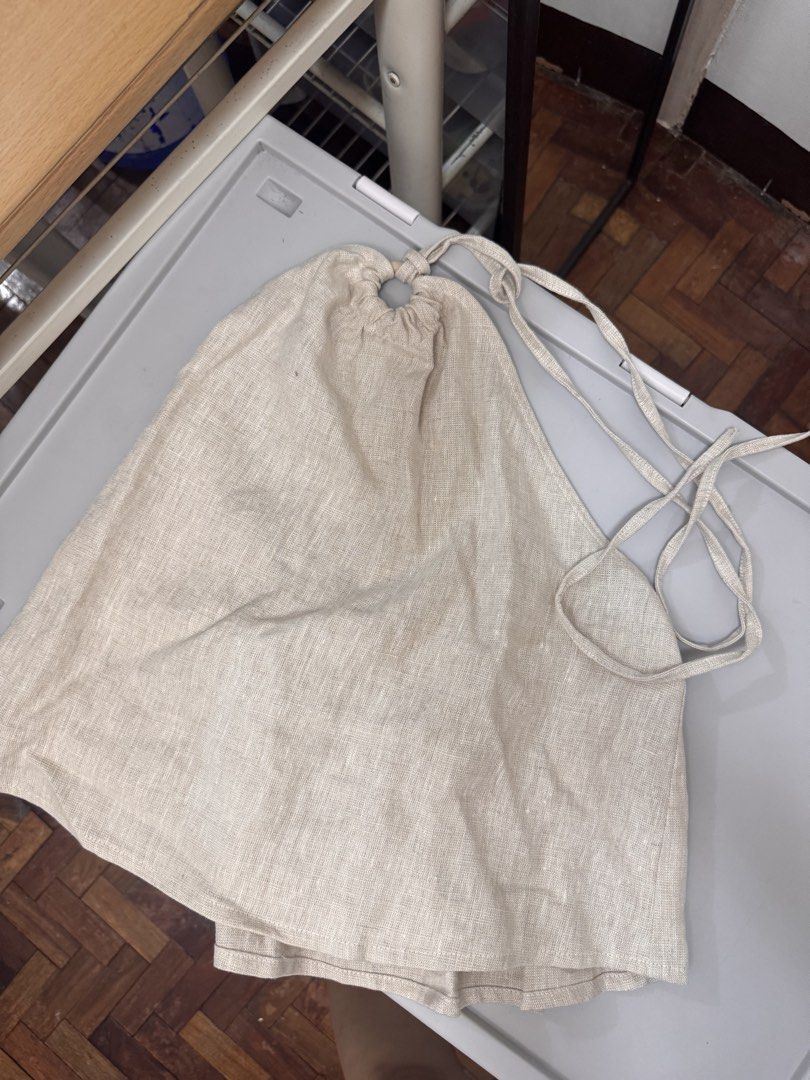 SHU SHI Linen Halter Top - Beige (Category: Sleeveless) located in Makati City. Submitted by prelovedbymich. (Listing ID 1459740243, Image 2). Description: - Brand: SHU SHI - Color: Beige - Size S - Style: Halter Top - Material: Linen - Condition: Brand new with tags attached - RFS: bought 2 by mistake.