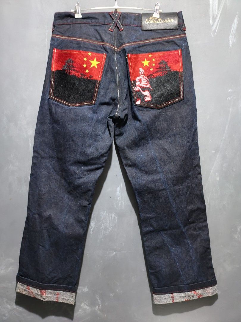 Soone denim pants (Category: Jeans) located in Taguig. Submitted by daily_hustle (Listing ID 1459716765, Image 2). Description: - Dark wash denim jeans from Soon Denim. - Unique embroidered back pockets featuring Chinese flags and a Terracotta Warrior design. - Cuffs have distinctive yellow and black stripes. - A cool statement piece to elevate your style..