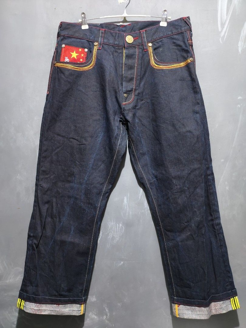 Soone denim pants (Category: Jeans) located in Taguig. Submitted by daily_hustle (Listing ID 1459716765, Image 1). Description: - Dark wash denim jeans from Soon Denim. - Unique embroidered back pockets featuring Chinese flags and a Terracotta Warrior design. - Cuffs have distinctive yellow and black stripes. - A cool statement piece to elevate your style..