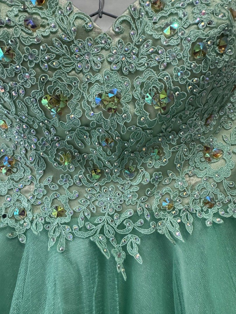 Sparkly Mint Green Strapless Party Dress (Category: Dresses) located in General Trias. Submitted by yuhgieros (Listing ID 1459739917, Image 3). Description: - Stunning mint green strapless dress - Intricate beadwork and sequins on the bodice - Layered tulle skirt with ruffled edges - Zipper closure at the back - Perfect for parties and special occasions.