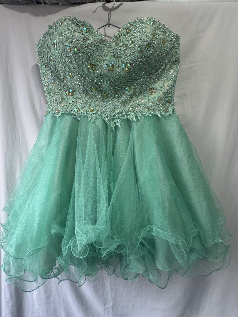 Sparkly Mint Green Strapless Party Dress (Category: Dresses) located in General Trias. Submitted by yuhgieros (Listing ID 1459739917, Image 1). Description: - Stunning mint green strapless dress - Intricate beadwork and sequins on the bodice - Layered tulle skirt with ruffled edges - Zipper closure at the back - Perfect for parties and special occasions.
