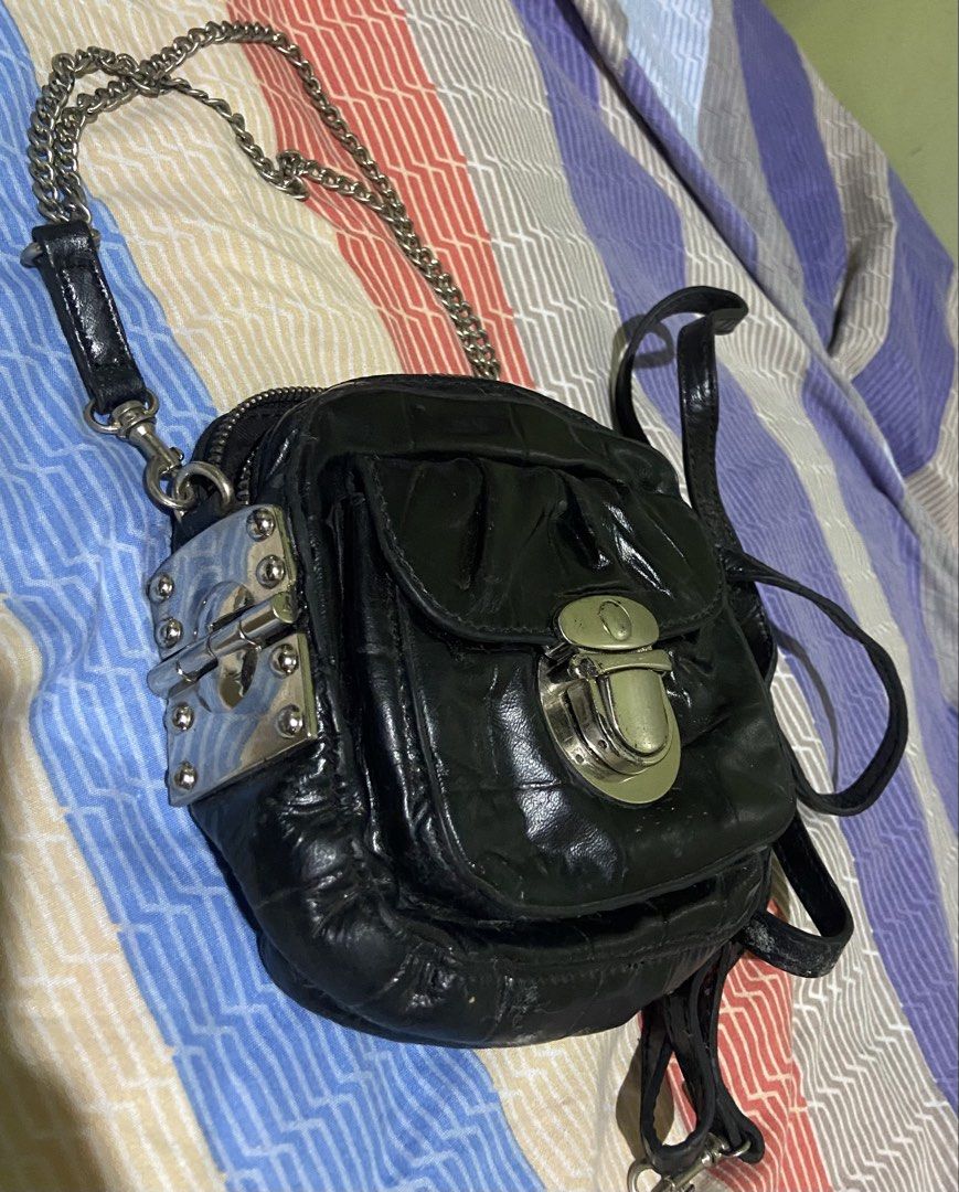 STACCATO Black Leather Quilted Chain Shoulder Bag (Category: Shoulder Bags) located in Tarlac. Submitted by pangz0918 (Listing ID 1459809044, Image 2). Description: - Brand: STACCATO - Material: Black Leather - Design: Quilted - Hardware: Silver turn-lock closure and chain strap - Straps: Silver chain strap and a longer leather strap - Compartments: Zippered main compartment with interior zippered pocket - Condition: Shows some signs of wear on l