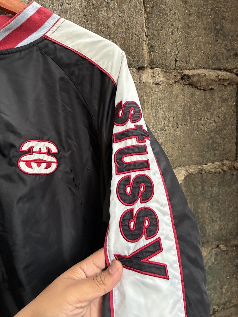 Stussy Varsity Jacket Black Red White (Category: Coats, Jackets and Outerwear) located in Manila. Submitted by assortedgoodsv3 (Listing ID 1459719736, Image 2). Description: - Classic Stussy varsity jacket - Color: Black with white sleeves and red trim - Features Stussy logo on chest - 'STUSSY' text detail down the sleeve - Button-up front closure - Quilted lining for warmth - Ideal addition to any streetwear collection.
