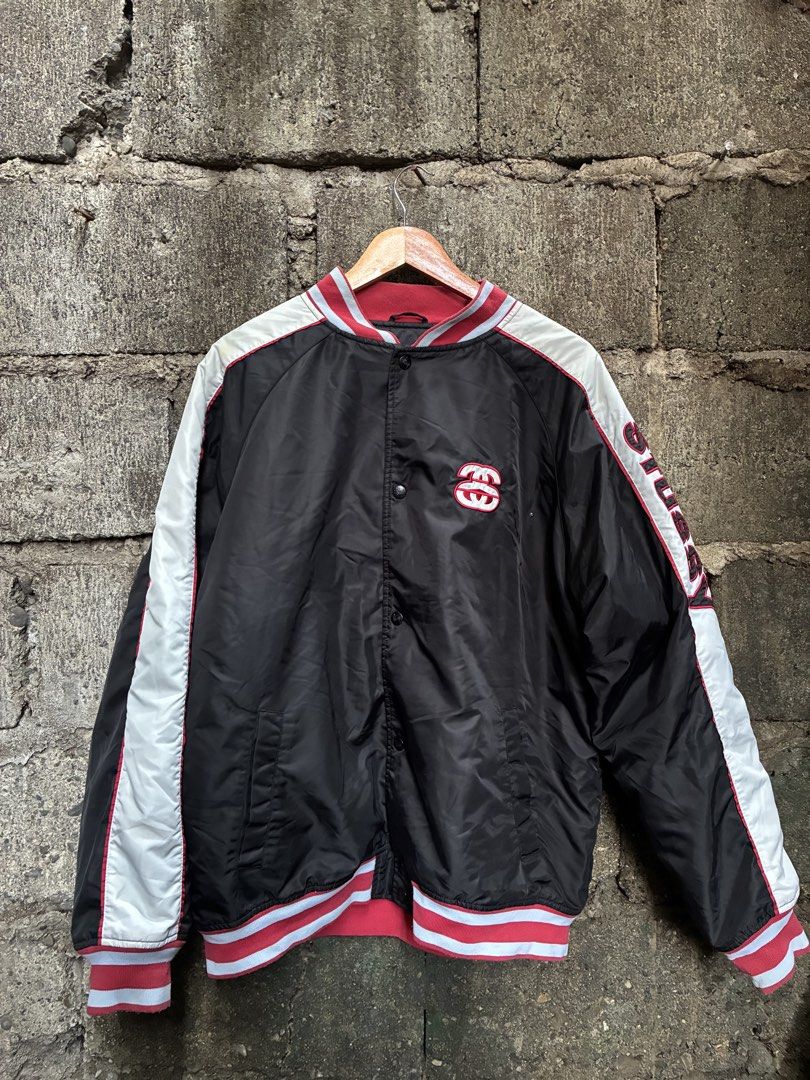 Stussy Varsity Jacket Black Red White (Category: Coats, Jackets and Outerwear) located in Manila. Submitted by assortedgoodsv3 (Listing ID 1459719736, Image 1). Description: - Classic Stussy varsity jacket - Color: Black with white sleeves and red trim - Features Stussy logo on chest - 'STUSSY' text detail down the sleeve - Button-up front closure - Quilted lining for warmth - Ideal addition to any streetwear collection.