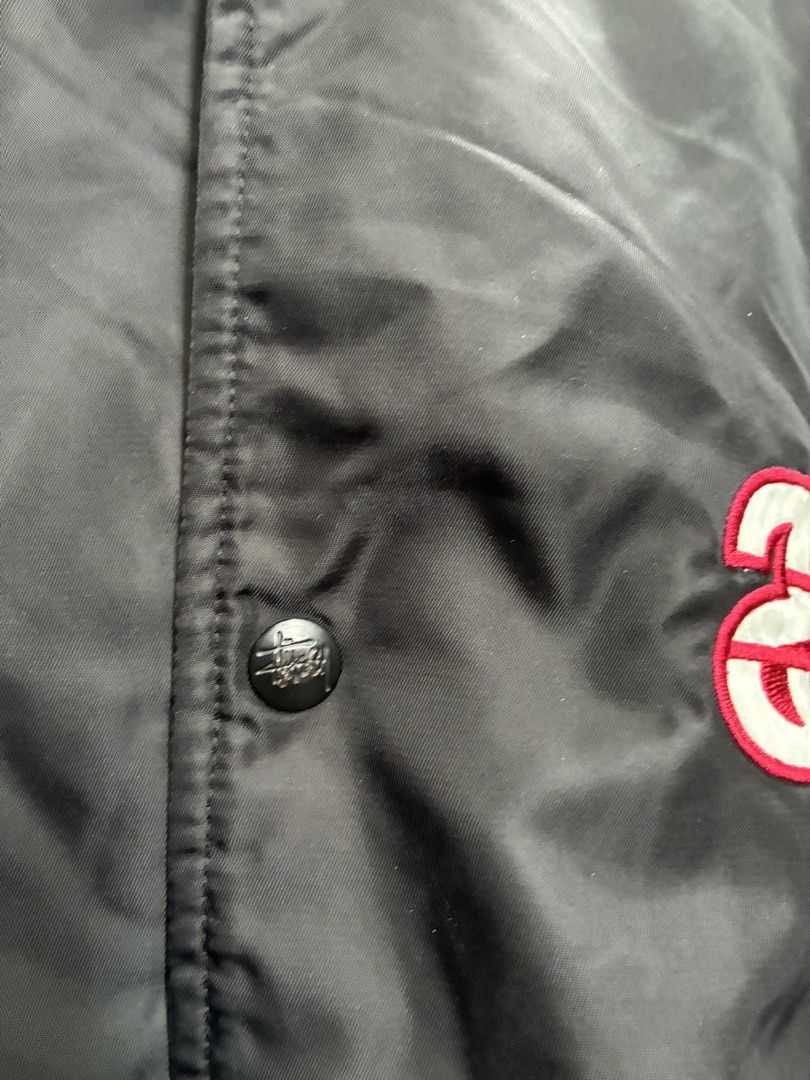 Stussy Varsity Jacket Black Red White (Category: Coats, Jackets and Outerwear) located in Manila. Submitted by assortedgoodsv3 (Listing ID 1459719736, Image 3). Description: - Classic Stussy varsity jacket - Color: Black with white sleeves and red trim - Features Stussy logo on chest - 'STUSSY' text detail down the sleeve - Button-up front closure - Quilted lining for warmth - Ideal addition to any streetwear collection.