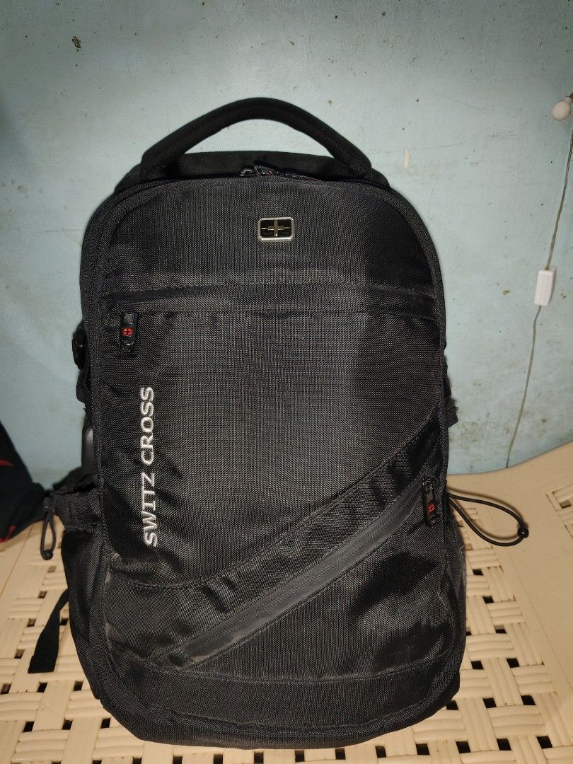 SWITZ CROSS Black Backpack (Category: Backpacks) located in Manila. Submitted by goldeneagle-41fe (Listing ID 1459842171, Image 1). Description: - Brand: SWITZ CROSS - size 18×12×8 - good condition 10/10 - color rate 10/0 - Color: Black - Features: Multiple zippered compartments for organization - Comfort: Padded straps - Durability: Made with durable material - Ideal for: School or travel - Security: Zippers have built-in locks.