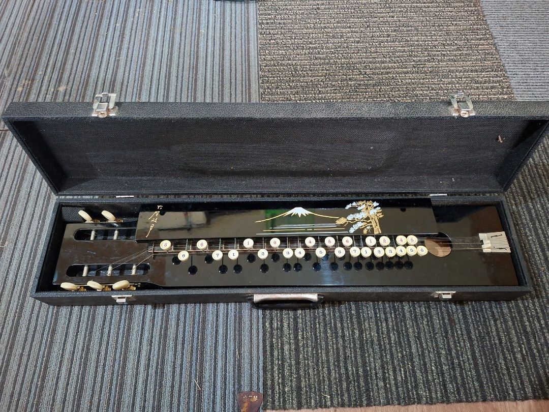 Taishogoto / Nagoya Harp (Category: Musical Instruments) located in Consolacion. Submitted by luxekerei (Listing ID 1453142070, Image 1). Description: - a traditional japanese plucked string instrument featuring a typewriter like keyboard layout on a glossy black body decorated with a mount fuji and a pine tree motif.