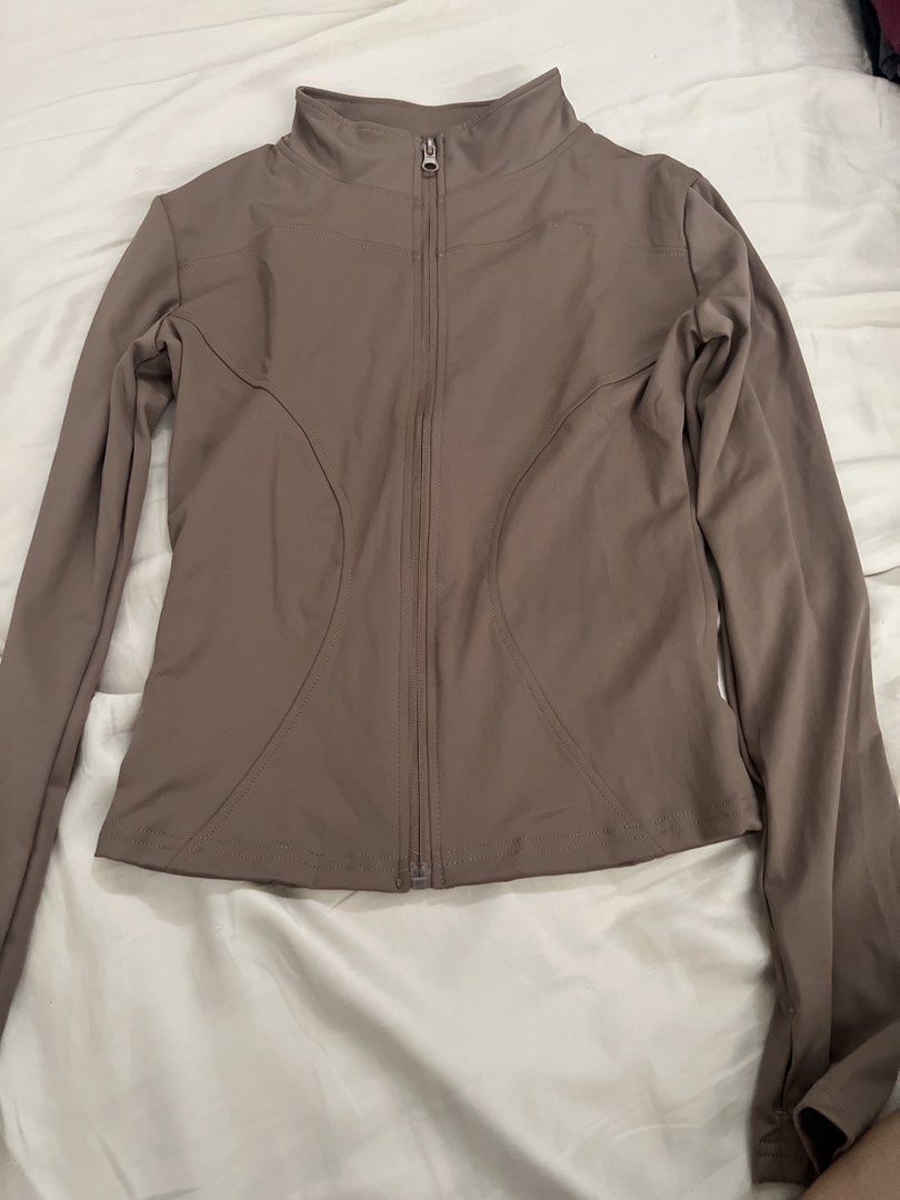 Taupe Zip-Up Gym Jacket (Category: Coats, Jackets and Outerwear) located in Pasig City. Submitted by crybaby666 (Listing ID 1459759421, Image 1). Description: - Taupe long sleeve zip-up jacket - High neckline with full zip closure - Fitted silhouette with front curved seams - Thumbholes on cuffs - Ideal for layering or activewear.
