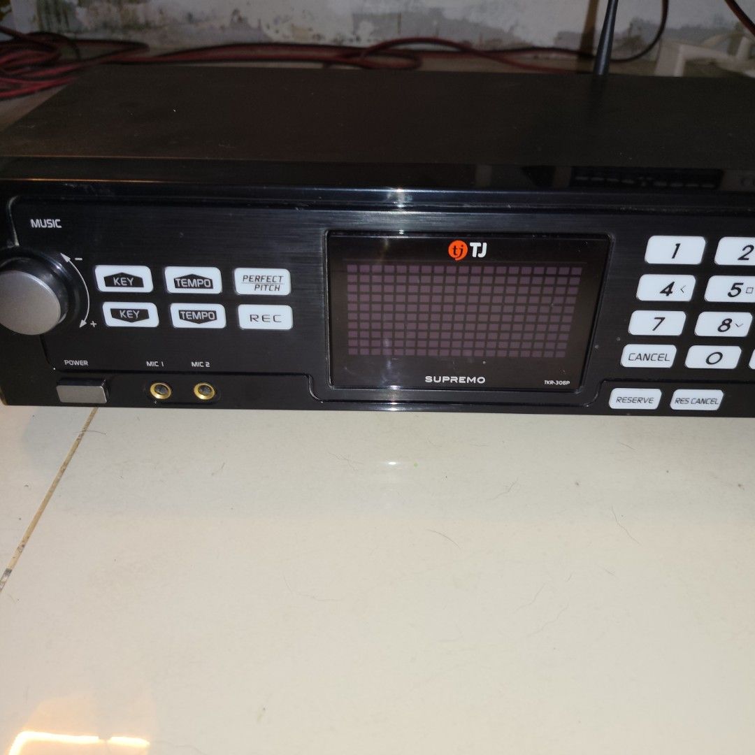 TJ Supremo TKR-300P Karaoke Player (Category: Portable Music Players) located in San Jose del Monte. Submitted by grace36th (Listing ID 1459704486, Image 2). Description: - TJ Supremo TKR-300P Karaoke Player - Music controls: Key and Tempo adjustment - Special features: Perfect Pitch and Record function - Connectivity: Two microphone inputs - Display: Shows song information - User-friendly buttons: Number selection, Cancel, Reserve, Res-Cancel.