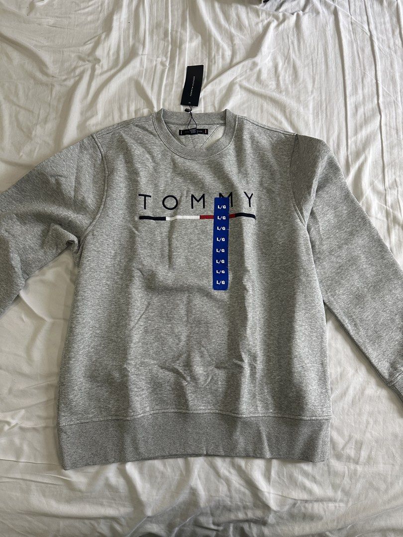 Tommy Hilfiger Grey Crewneck Sweatshirt (Category: Coats, Jackets and Outerwear) located in Manila. Submitted by dihlicious (Listing ID 1459841762, Image 1). Description: Tommy Hilfiger Sweater Grey - L Bought in Canada Lowest price in the market Market is 4-5k Negotiable.