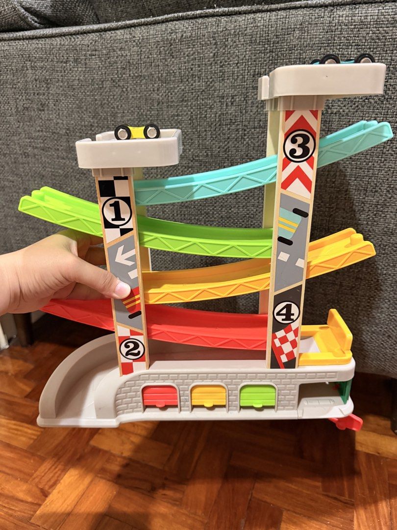 Topbright City Ramp Racer (Category: Educational & Learning Toys) located in Quezon City. Submitted by eimaj08 (Listing ID 1459826929, Image 2). Description: - Fun wooden car ramp racer by Topbright - Comes with 4 numbered cars: green, orange, blue, and yellow. - Watch cars zoom down colorful ramps. - Great for learning numbers and colors. - Includes original box..