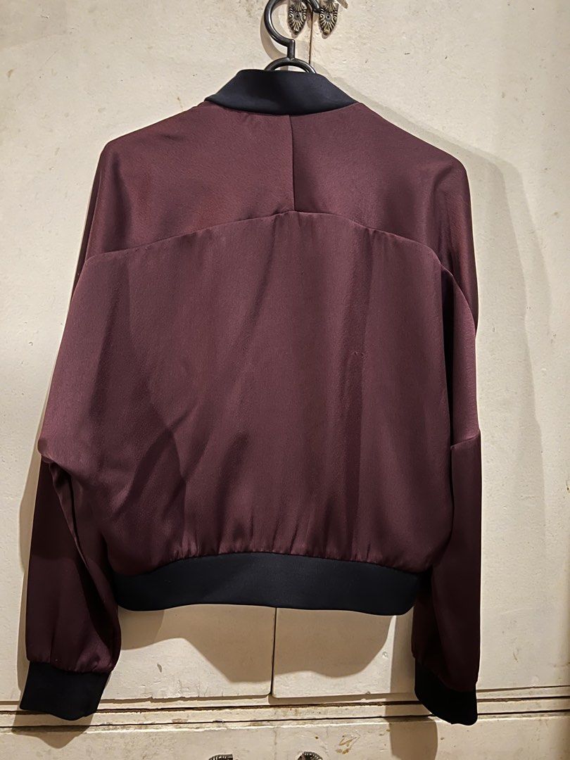 Topshop Burgundy Satin Bomber Jacket (Category: Coats, Jackets and Outerwear) located in Manila. Submitted by mkeconsil58884 (Listing ID 1459816725, Image 2). Description: - Burgundy satin bomber jacket by Topshop - Classic black collar, cuffs, and hem - Zip-up front closure - Two convenient side pockets - Effortlessly stylish for dressing up or down - Made in Romania.