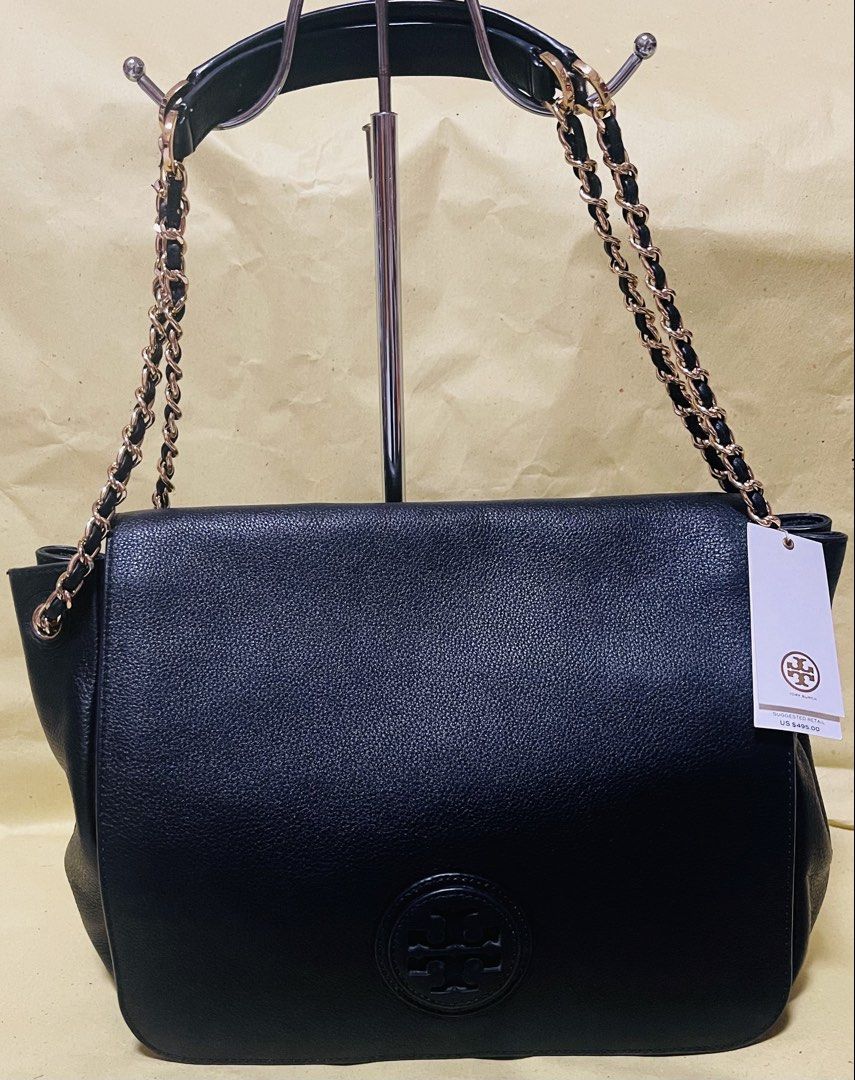 Tory Burch Black Leather Chain Shoulder Bag (Category: Shoulder Bags) located in Manila. Submitted by ermenchita71969 (Listing ID 1459845954, Image 1). Description: - Authentic Tory Burch black leather shoulder bag - Elegant gold chain strap - Signature Tory Burch logo on front flap - Interior features zippered pockets and card slots - Comes with original tags attached - Versatile for everyday wear or evening events.