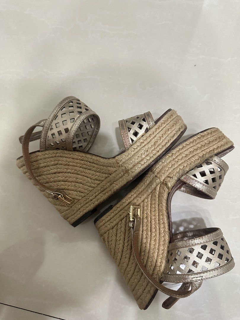 Tory Burch Espadrille Wedge Sandals (Category: Heels) located in Manila. Submitted by allthingsilove65 (Listing ID 1459783617, Image 3). Description: Metallic gold perforated leather with lattice cut-out straps, jute-wrapped wedge, ankle buckle with gold “TORY BURCH” hardware. Tan leather footbed with embossed TB logo. Approx. 3.5–4 inch heel with slight platform — surprisingly walkable Goes well with any outfit Authentic .