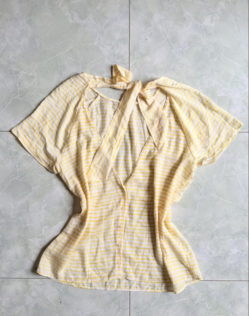 TRAFALUC Yellow Striped Tie Back Top (Category: Blouses) located in General Santos City (Dadiangas). Submitted by ssssshhhhhhhhh (Listing ID 1459743978, Image 3). Description: - Cute yellow and white striped top from TRAFALUC. - Short sleeves with a tie detail at the back. - Functional buttons down the front. - Minor mark on the sleeve (refer to the last photo). - Ideal for casual everyday wear..