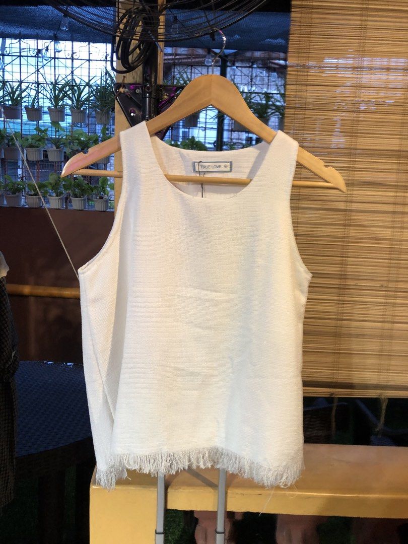 True Love White Fringed Tank Top (Category: Sleeveless) located in Cauayan City . Submitted by wholly.craaaft (Listing ID 1459798593, Image 1). Description: - Brand: True Love - Type: Sleeveless Tank Top - Color: White - Fabric: Textured weave - Detail: Raw fringe hem - Condition: Small faint mark on front (visible in last photo) - Occasion: Casual wear.