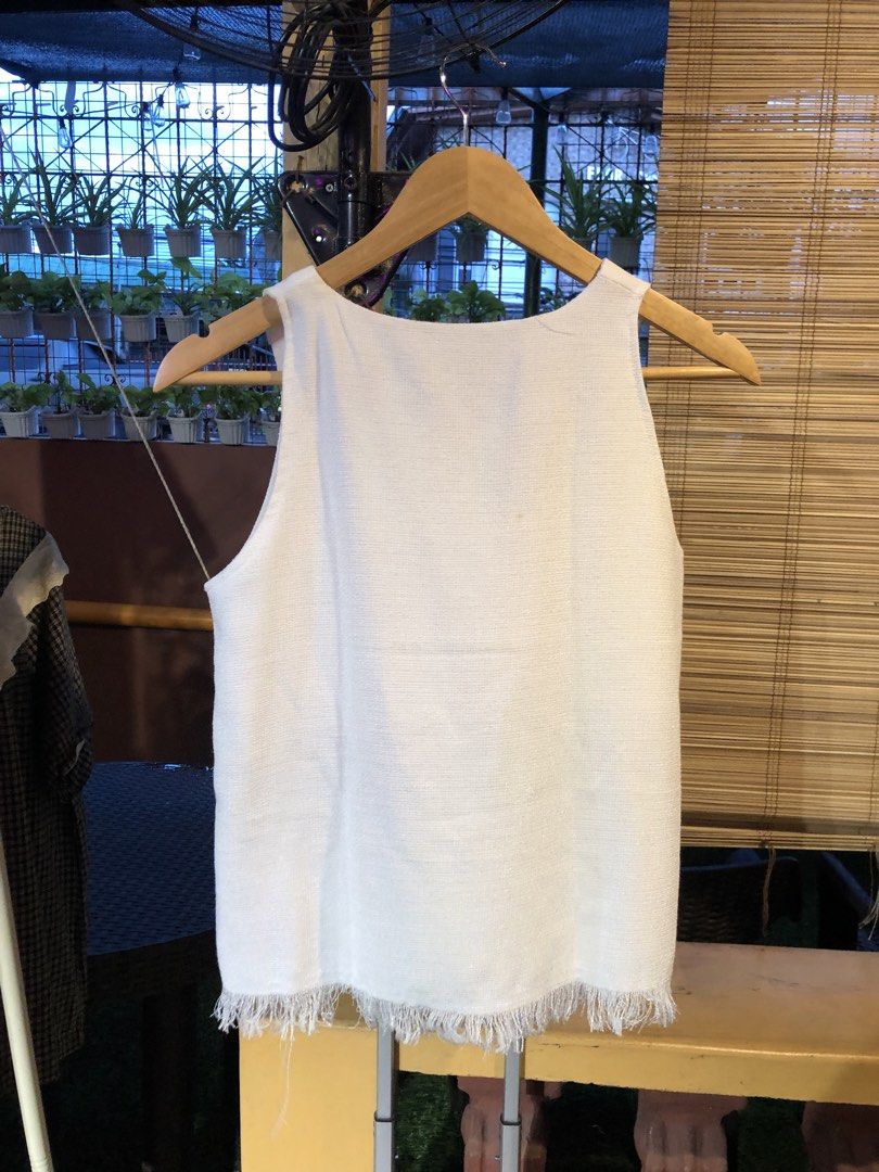 True Love White Fringed Tank Top (Category: Sleeveless) located in Cauayan City . Submitted by wholly.craaaft (Listing ID 1459798593, Image 3). Description: - Brand: True Love - Type: Sleeveless Tank Top - Color: White - Fabric: Textured weave - Detail: Raw fringe hem - Condition: Small faint mark on front (visible in last photo) - Occasion: Casual wear.