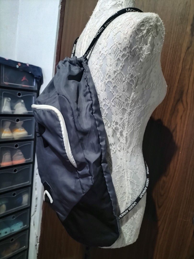 Under Armour Sackpack / Drawstring Bag (Black) (Category: Backpacks) located in Batangas. Submitted by dinafrago (Listing ID 1459808448, Image 3). Description: Brand: Under Armour Type: Drawstring Sackpack / Gym Bag Color: Black with white trim/zipper Origin: Bought in Canada 🇨🇦 Features: Front zippered compartment with printed logo Main drawstring compartment Adjustable Under Armour branded shoulder straps with sternum clip Note on strap Attac