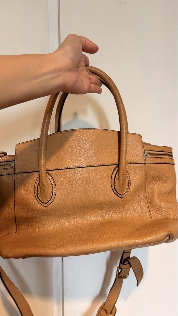 Vera Wang two-way Handbag (Category: Cross-body Bags) located in Quezon City. Submitted by abiclarisse (Listing ID 1459764085, Image 3). Description: Authentic Vera Wang 2-way handbag in tan/caramel. Can be used as a handbag or shoulder/crossbody bag. Good overall condition with only minimal scratches/signs of use. No major damage or issues. Complete with adjustable/detachable shoulder strap. Selling for ₱1,500 negotiable. RFS: Decluttering Pleas