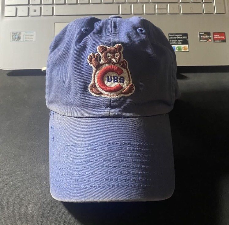 Vintage Blue Chicago Cubs Bear Baseball Cap (Category: Caps & Hats) located in Manila. Submitted by bd10eclutters (Listing ID 1459884329, Image 2). Description: - Blue Chicago Cubs baseball cap - Features a cute bear graphic holding 'CUBS' lettering - Perfect for any Chicago Cubs fan - Shows some signs of wear, particularly on the brim.