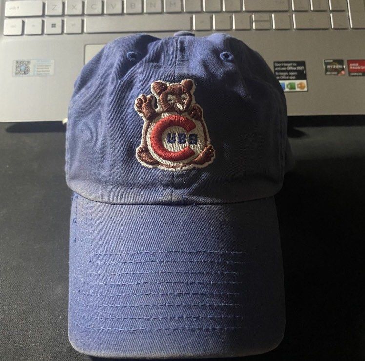 Vintage Blue Chicago Cubs Bear Baseball Cap (Category: Caps & Hats) located in Manila. Submitted by bd10eclutters (Listing ID 1459884329, Image 1). Description: - Blue Chicago Cubs baseball cap - Features a cute bear graphic holding 'CUBS' lettering - Perfect for any Chicago Cubs fan - Shows some signs of wear, particularly on the brim.