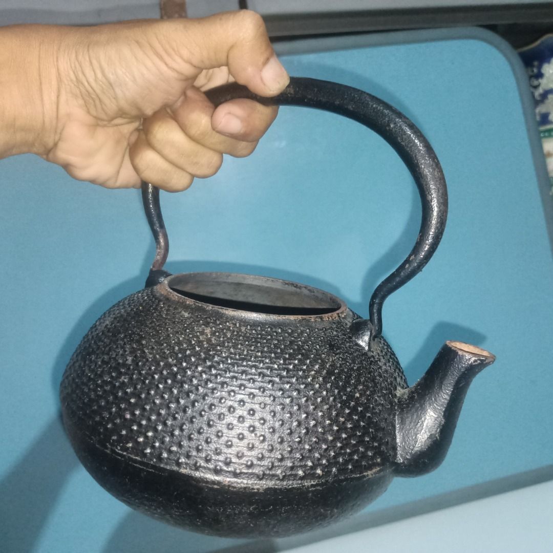 Vintage Cast Iron Teapot Kettle Medium Size (Category: Coffee & Tea Tableware) located in Munoz. Submitted by larryc1212 (Listing ID 1459821571, Image 2). Description: - Classic cast iron teapot - Unique textured exterior - Sturdy handle and spout - Ideal for tea lovers or as a decorative piece - Vintage charm with signs of age and use - Approximately 7.5 inches tall (including handle) Disclaimer: Item may include some scratches due to age, as is