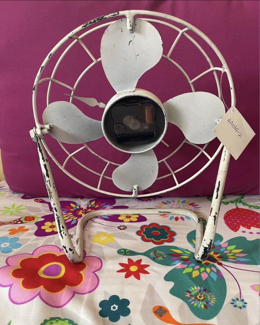 Vintage Style Fan Clock (Category: Clocks) located in Manila. Submitted by immrsa (Listing ID 1459899653, Image 2). Description: - Retro fan design clock - Distressed white metal frame - Visible clock mechanism at the center - Includes a stand for tabletop display - Perfect unique decorative piece for your desk or shelf.