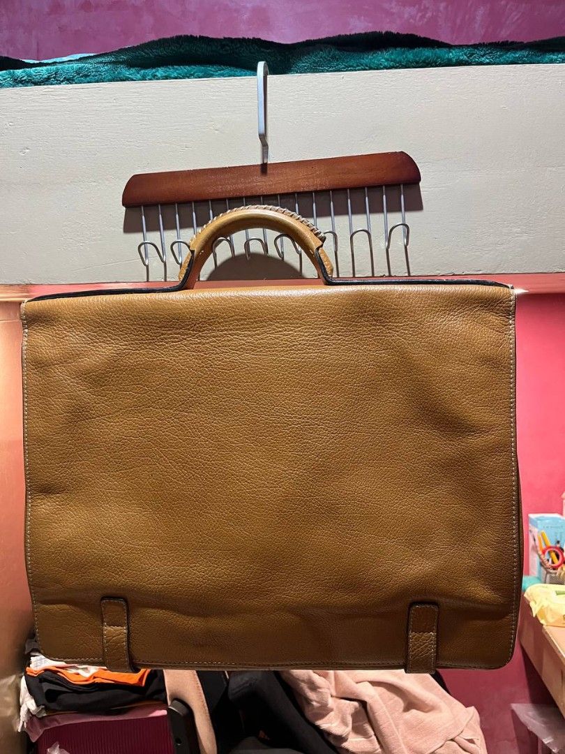 vintage tan leather briefcase satchel bag (Category: Briefcases) located in Quezon City. Submitted by alternativefinds (Listing ID 1459876292, Image 2). Description: vintage tan leather briefcase satchel bag Vintage Tan Leather Briefcase / Satchel Bag Description:Selling this classic, structured tan leather briefcase. Features a beautiful pebbled texture, dual front strap buckle details, a sturdy top handle, and a central combination lock for ext
